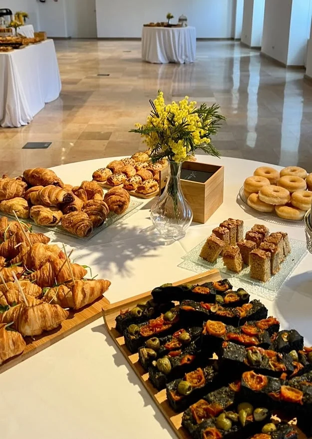 Bufet d'esmorzar amb croissants, brioixeria, donuts i coca amb olives